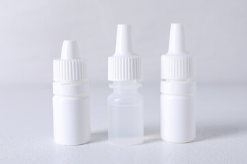 Bottles of medical drops on white background