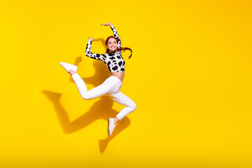 Full length profile photo of charming lovely person jumping freedom empty space isolated on yellow...