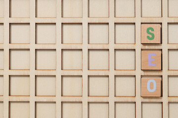 Wooden box with cells and wooden cubes with letters, top view