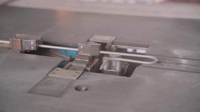 Factory production of heating element. Heating exchanger workshop. Industrial machine bending metal rod. Manufacturing heating element. Mass factory production.