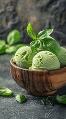 wooden bowl with green basil ice cream on a rustic background, in a closeup view, copy space concept for summer food and menu design. 