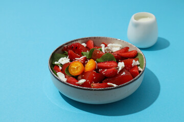 Fresh watermelon salad in a bowl on a blue background