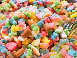 Sweets and Candy Close up - Indulge in the Sweet Avalanche, A Tempting Mountain of Colourful Fruity Confectionery Delights. Unhealthy diabetic and sugar addiction concept