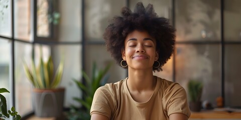 Smiling Woman Practicing Mindfulness Techniques in Cozy Workplace Environment for Improved Employee Satisfaction and Wellbeing