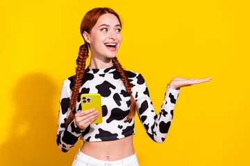 Photo of sweet impressed woman wear cow skin print top chatting modern gadget holding arm empty...