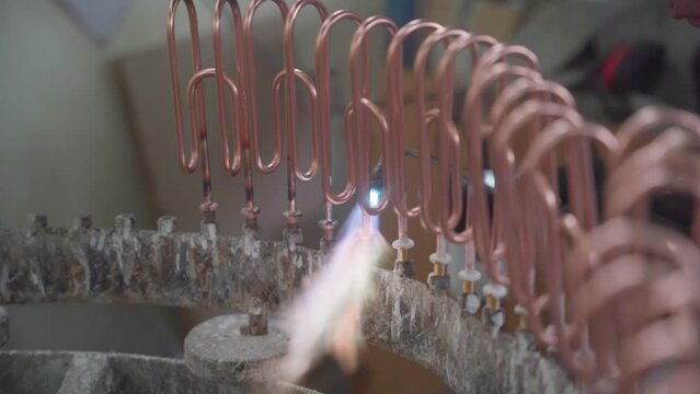 Factory production of heating element. Welding of Heating exchanger in workshop. Manufacturing heating element. Mass factory production.