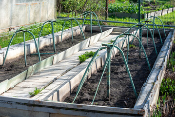 Low greenhouse is prepared for planting seedlings.