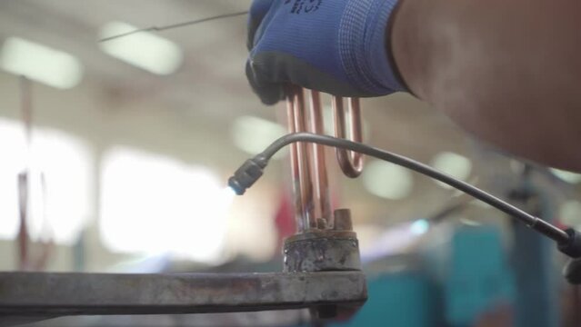 Factory production of heating element. Welding of Heating exchanger in workshop. Manufacturing heating element. Mass factory production.