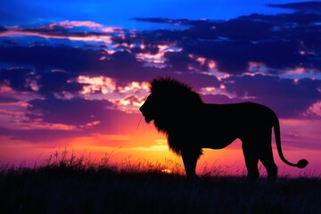 A majestic lion silhouetted against a vibrant sunrise on the African savanna.