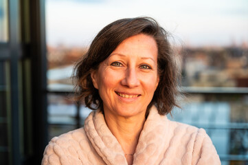 Portrait of a smiling 50 yo woman with a city background, Brussels, Belgium