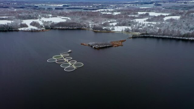 Aerial Symphony. Snow Kissed Fish Cages in Winter Quietude. Aerial drone shot