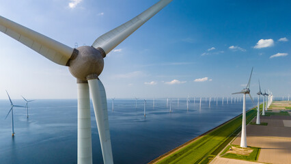 Aerial view of windmill turbines spinning gracefully in a wind farm near the ocean in the...