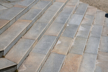 wide staircase with granite steps, fan-shaped opening with elements of very precious gray stone. construction detail of external staircase.