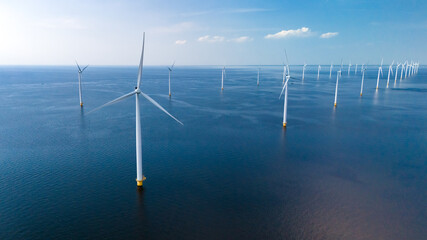 A vast expanse of wind turbines scattered across the ocean, their blades turning gracefully in the...