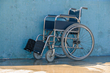Empty wheelchair at accessible pool for assistance to help people with disabilities.
