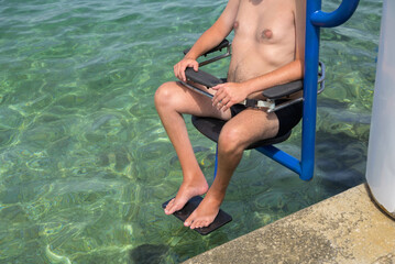 Swimming lift at sea for people with disability. Accessible beach and access to water.