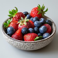 A bowl of fresh strawberries and blueberries.