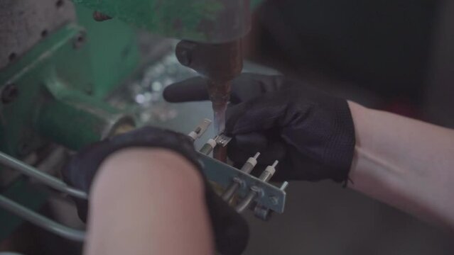 Factory production of heating element. Punctuation or point welding of Heating exchanger in workshop. Close up.