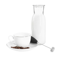 Mini mixer (milk frother), cup, coffee beans and bottle isolated on white