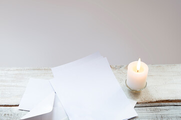 Envelope and paper on white wooden table