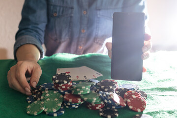 Women's hands shuffle cards. Concept of playing poker on the table with chips and cards. Gambling...