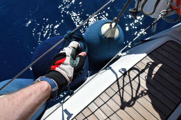 Sailing. Fenders and mans hand