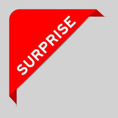 Red color of corner label banner with word surprise on gray background