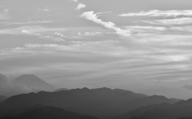 Black and white photo of Mount Fuji and swirling clouds