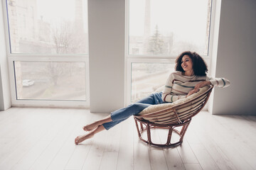 Photo portrait of attractive young woman sit armchair look empty space dressed casual clothes cozy...