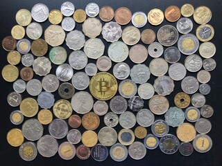 View of bitcoin symbol surrounding with coins from all over the world