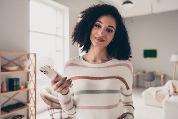Photo of dreamy sweet lady dressed striped pullover typing messages modern device indoors apartment...