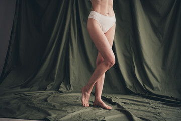Cropped unretouched photo of old lady posing wear white panties isolated green color linen...