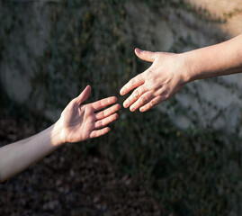 Man reaching out to help his friend