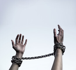 Praying man with shackled hands