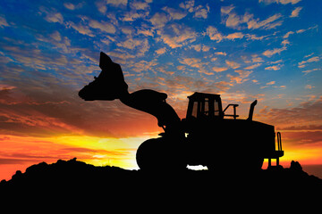 Wheel loader  silhouette are digging the soil in the construction site.With on  cloud and sky  background.