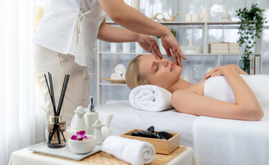 Caucasian woman enjoying relaxing anti-stress head massage and pampering facial beauty skin...