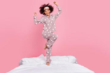 Photo of carefree lucky lady wear pajama rising fists having fun isolated pink color background