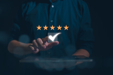 Customer service satisfaction survey concept.Business people or customers show satisfaction by pressing tick mark with five stars in satisfaction on virtual touch screen pop up on digital tablet