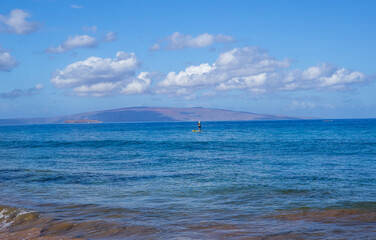 Paddleboarder off Maui with Big Island in Distance