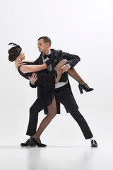 Passion in eyesight. Elegant young couple, man and woman in retro clothes dancing with feelings...