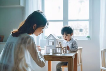 Obraz premium Diverse Asian mother and son build wooden toy doll house in cozy white room