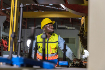 Black man factory worker working in metal sheet manufacturing industrial