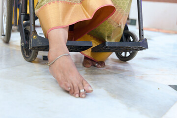 Handicapped woman in a wheelchair on the floor of a hospital