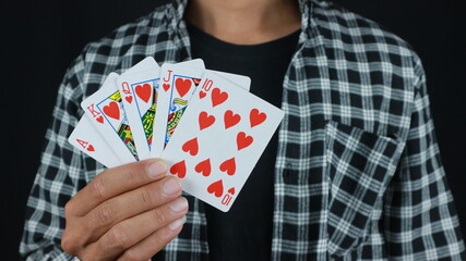 Gambling concept. Close up of Poker Player male hand Winning Royal Flush , gambling club.
