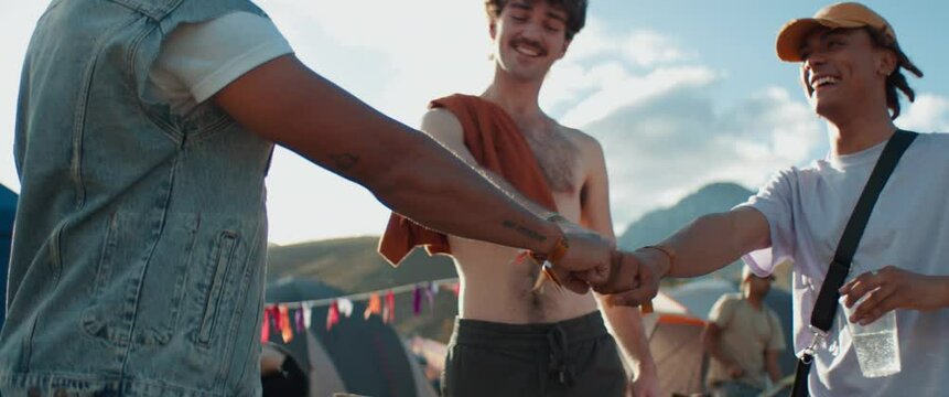 Close up fist bump of friends at festival having fun