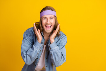 Photo portrait of attractive young hippie man raise hands excited wear trendy denim outfit isolated...