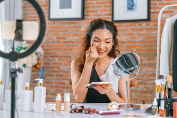 Woman influencer shoot live streaming vlog video review makeup uttermost social media or blog....