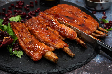 Vegan rack of  bbq ribs made with gluten and lemongrass stalks, on slate platter, stylish set up