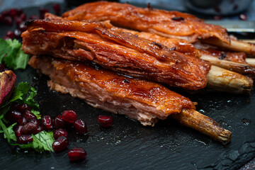 Vegan rack of  bbq ribs made with gluten and lemongrass stalks, on slate platter, stylish set up