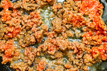 fried minced meat in a frying pan close-up